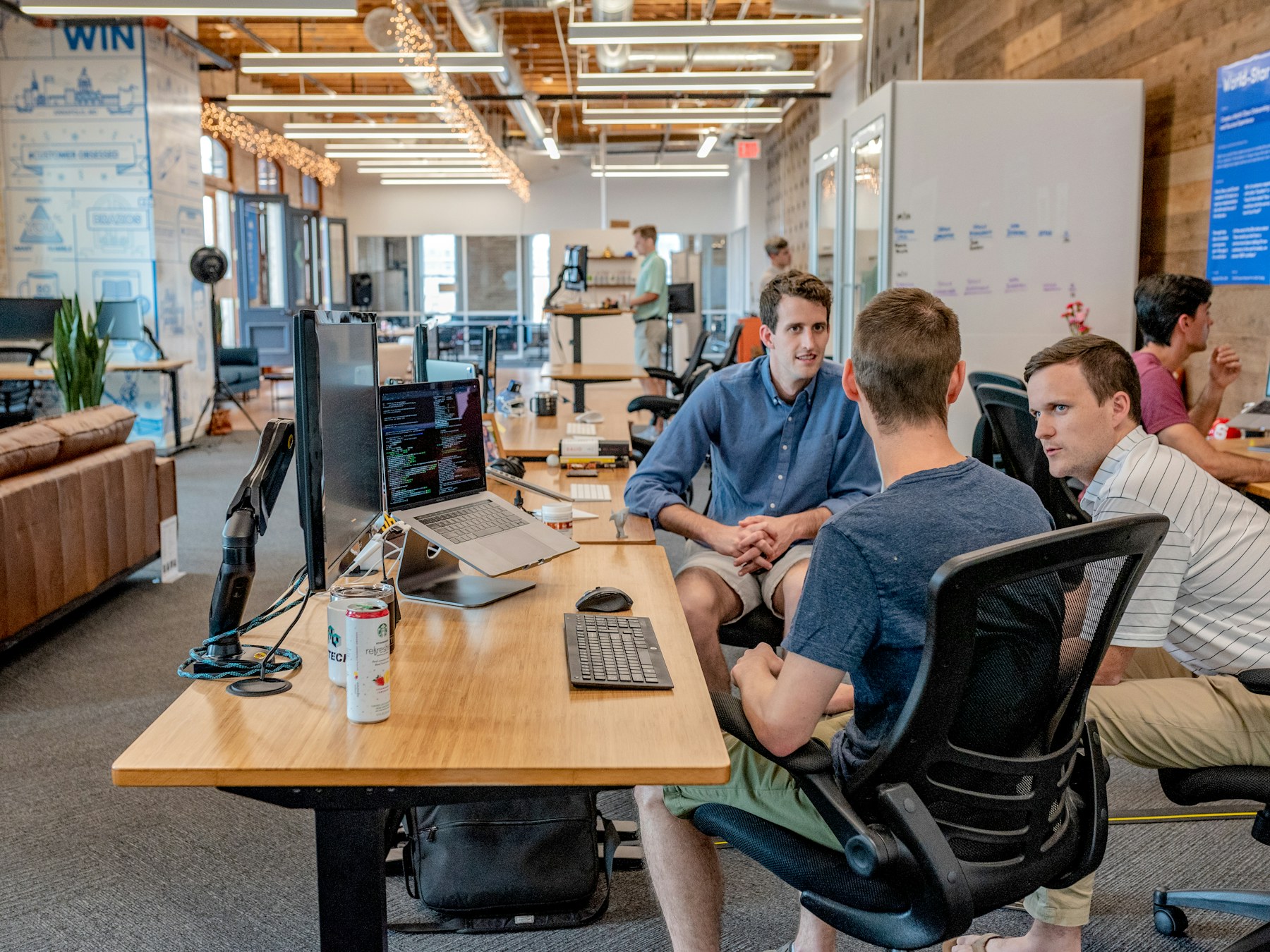 A team gathered around a screen in a bright studio